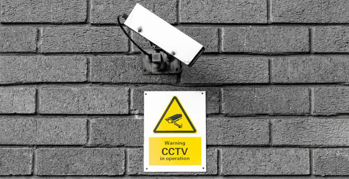 Bild av en övervakningskamera mot en tegelvägg.