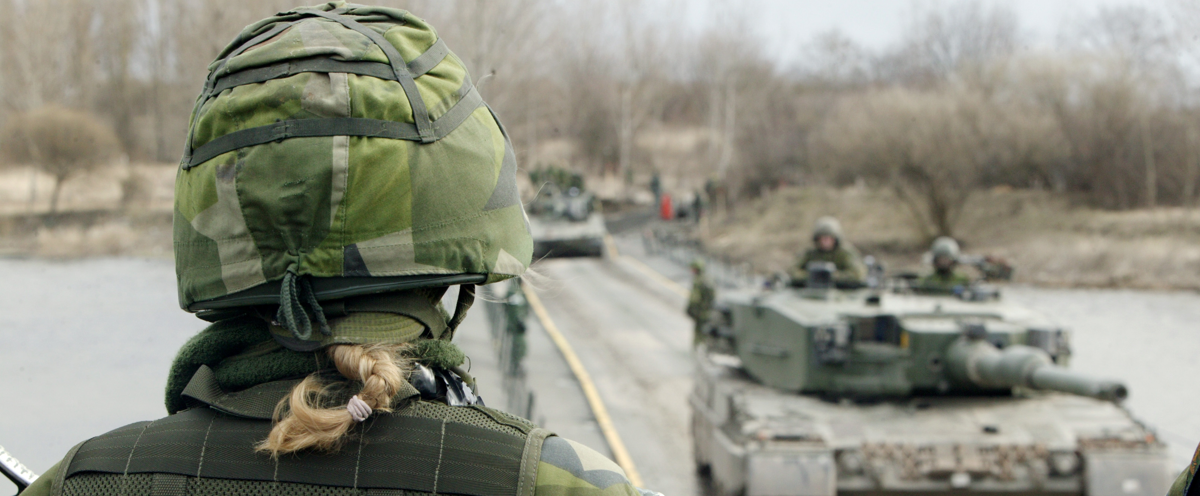 A couple of tanks that are on a road.