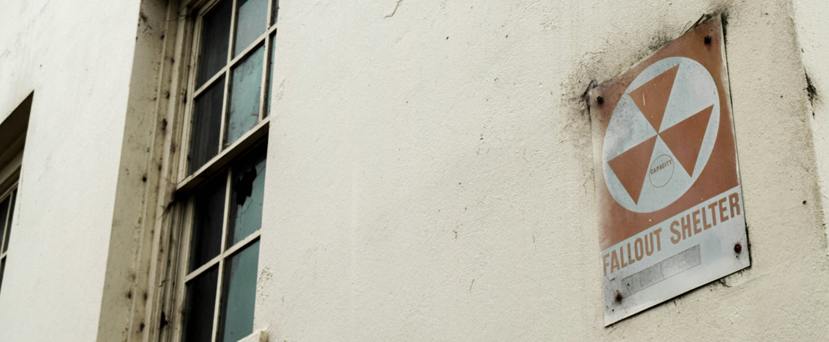 A red and white sign on the side of a building.