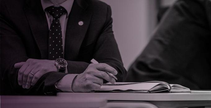 Arms crossed on a table.