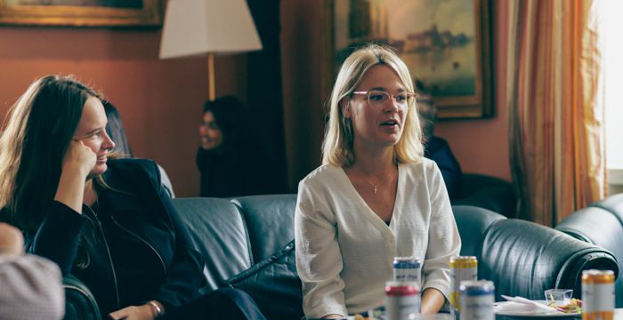Two female students in one of the sofas at the Officers' Mass.