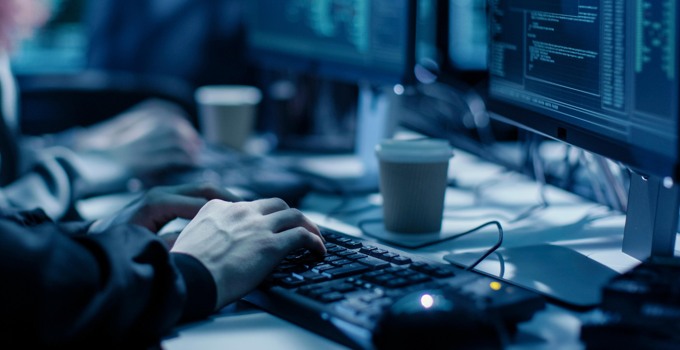 Närbild på händer vid ett tangentbord.